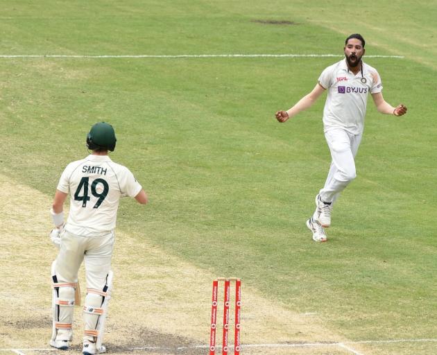 Mohammed Siraj celebrates the wicket of Steve Smith at the Gabba yesterday during the fourth test...