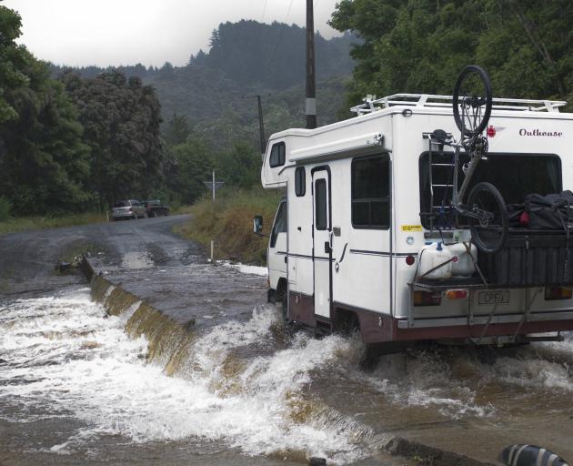 A campervan crosses the Silverstream ford after leaving the Whare Flat Folk Festival at the...