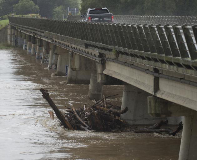 Flood debris is trapped under the Outram Bridge during the weekend’s heavy rain. PHOTO: GERARD O...