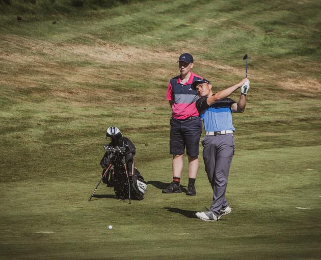  Parker Aluesi, watched by his father, Mike, plays the game he loves. PHOTO: SUPPLIED