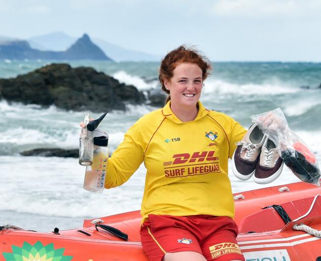 Brighton Surf Life Saving Club member Phoebe Aburn (19) shows some of the rubbish left on...