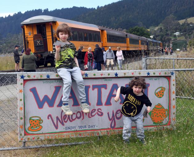 Max Merino Douat (5,  left) and Oliver Merino Douat (3) hand out flyers to Seasider train...