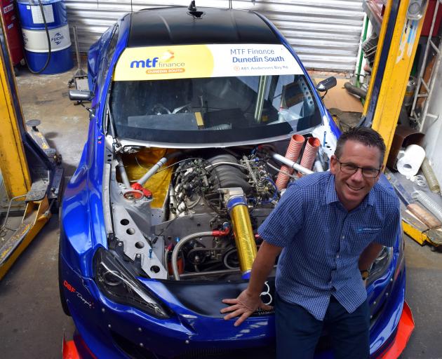 Chris Henderson, of Dunedin, relaxes on his 2012 Toyota GT86 race car in his workshop. PHOTO:...