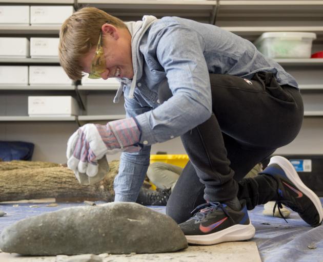 Waitara High School pupil Joseph Hill, of Taranaki, makes a stone tool at the University of Otago...
