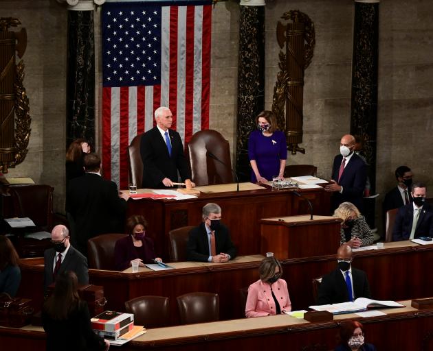 US Vice President Mike Pence speaks as U.S. House Speaker Nancy Pelosi listens during a joint session of the Congress to certify the 2020 election results on Capitol Hill in Washington. Photo: Reuters