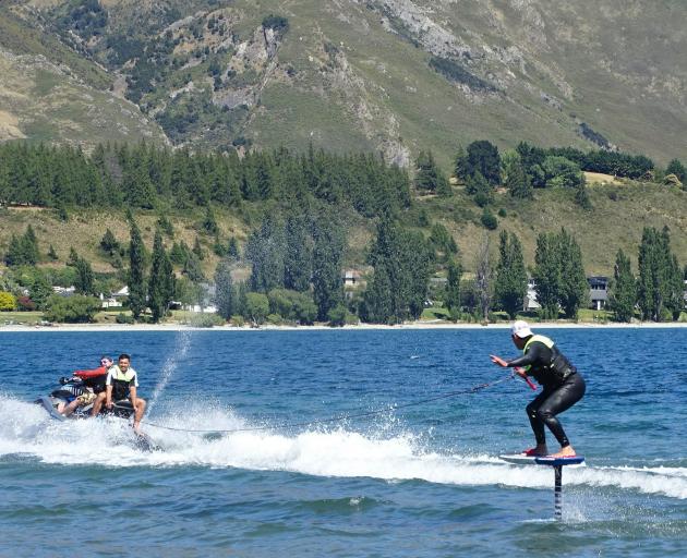 Kelly Gooch demonstrates the newly available activity of foil surfing on Lake Wanaka yesterday....