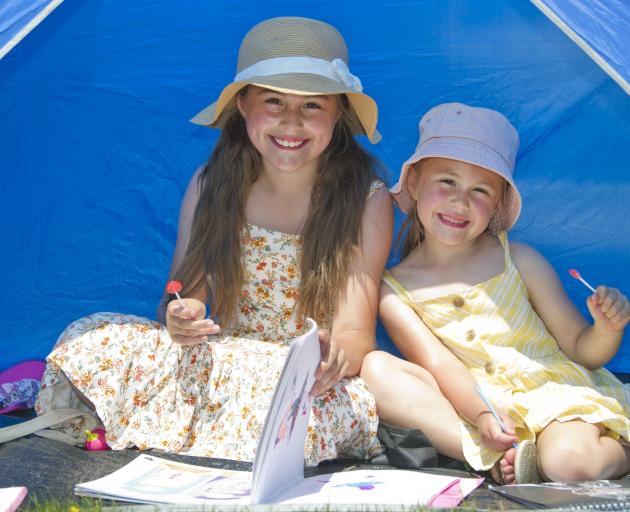 Ava (9) and Keira Goodman (5), of Dunedin, made the most of some shade at the Waikouaiti Racing...