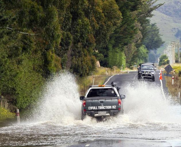 A vehicle cautiously crosses a water hazard on Allanton Rd yesterday. PHOTO: CHRISTINE O'CONNOR
