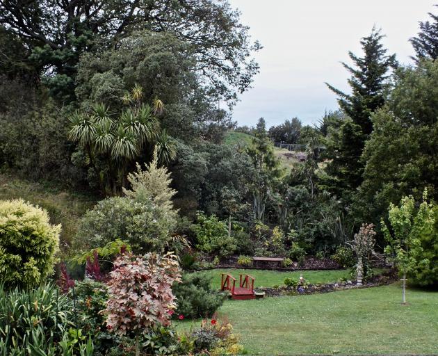 The rear of Stuart and Lesley Brown’s Waikouaiti garden ‘‘borrows’’ tall trees from 
...
