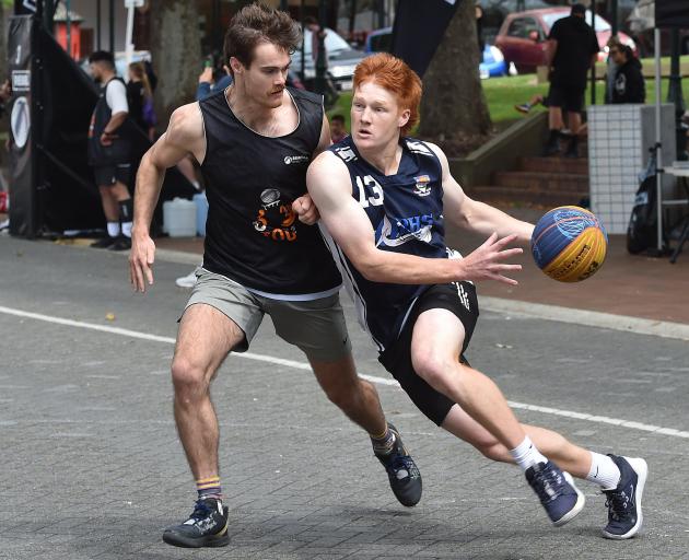 The Fellas guard Mitchell Hughan drives to the hoop as he is defended by Falcons guard Hamish...