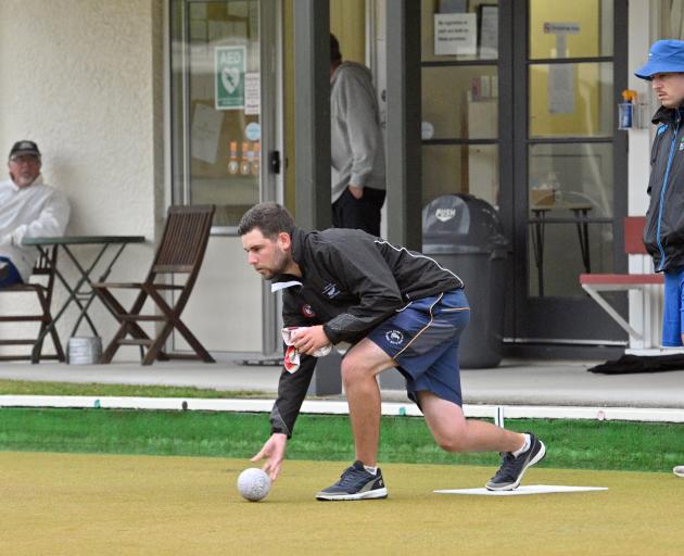 Elliot Mason delivers a bowl while Keanu Darby watches at the Wakari Bowling Club on Wednesday...
