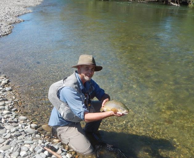 Bruce Quirey, my companion on the Mataura, with a nice trout on a perfect day.PHOTO: SUPPLIED