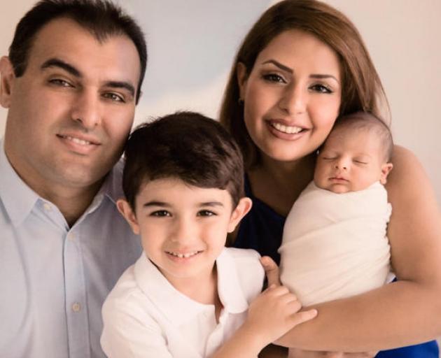 A family picture shows father Siamak, mother Mohadeseh and their sons Arteen (centre) and Radeen ...