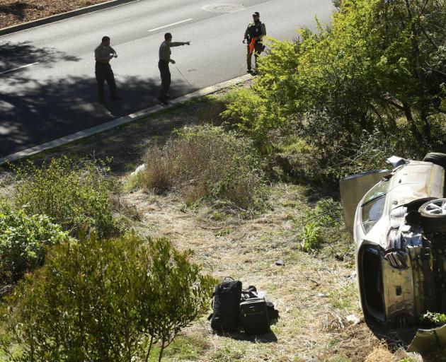L.A. County Sheriff's officers investigate an accident involving famous golfer Tiger Woods. Photo...