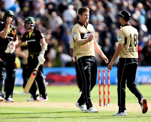 Black Caps bowlers Jimmy Neesham (left) and Trent Boult celebrate victory over Australia in the...