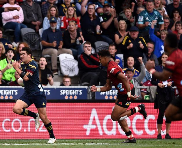 Connor Garden-Bachop runs away from the Crusaders defence on Friday night at Forsyth Barr Stadium...