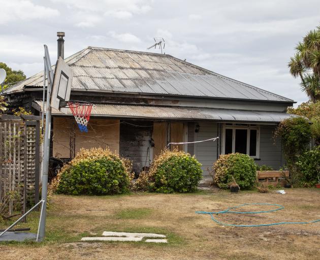 The Kirwee cottage was extensively damaged in a fire on Waitangi Day. Photo: Geoff Sloan