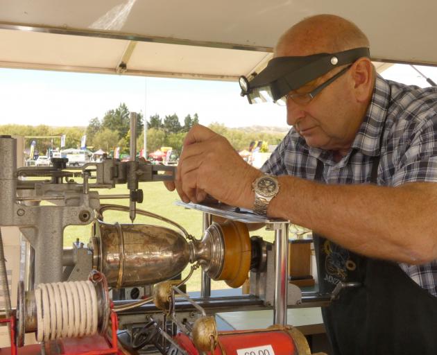 Stu Ide works to engrave the trophies at the Central Otago A&P Show in Omakau. PHOTO: ALEXIA...