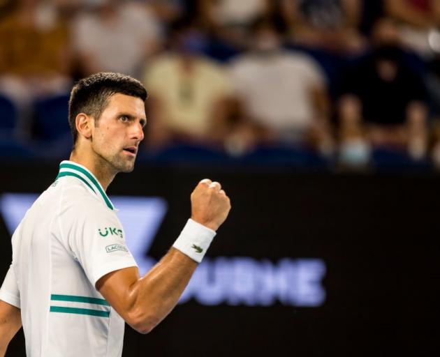 Novak Djokovic celebrates winning his semifinal at the Australian Open last night. Photo: Getty...