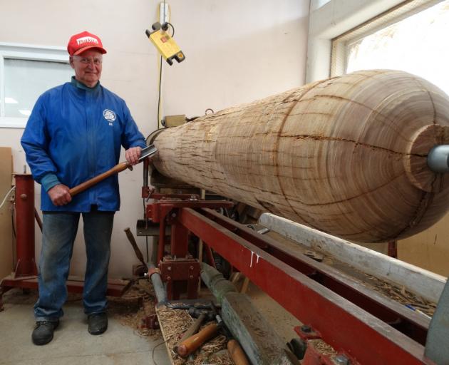 Waitaki Woodturners Guild treasurer Bill Owen gets ready to reshape an old power pole, which will...