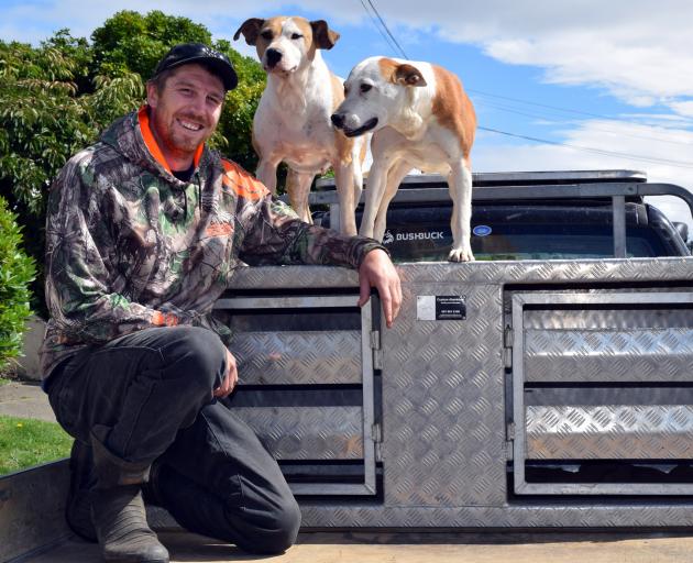 Taieri District Pig Hunting Club president Brandon Young, of Mosgiel, and his pig dogs Ice and...