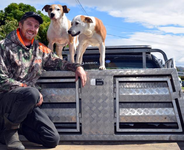 Taieri District Pig Hunting Club president Brandon Young, of Mosgiel, and his pig dogs Ice and...