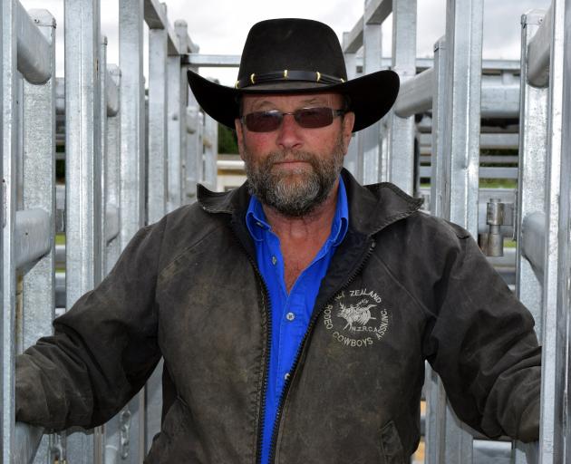 Outram Rodeo Club member Fred Doherty opens a gate in the new steel stockyards set for use during...