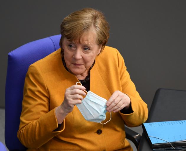 Chancellor Angela Merkel acknowledged her mistake before lawmakers, some of whom heckled her. She...