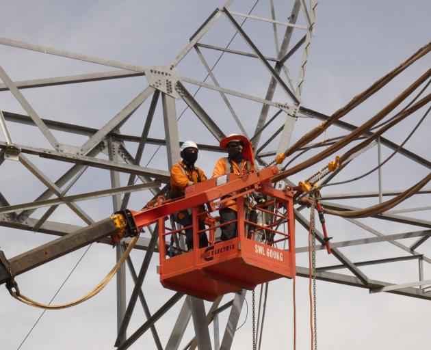 Workers at the top of a tower on the Transpower Roxburgh-Islington line near Roxburgh.