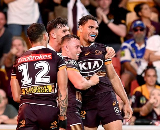Brisbane Broncos players celebrate after a try last week. Photo: Getty Images