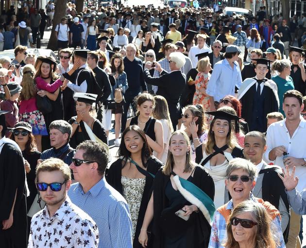 More than 220 University of Otago graduates parade through George St on Saturday afternoon as...