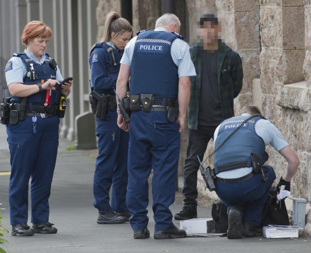 Dunedin police officers search a man’s bag in Princes St after an alleged attempt to steal...