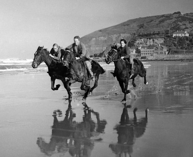 Galloping along the sand in a now-well-known 1958 shot are (from left) Alison Lindsay (nee Dean,...