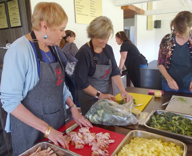 Food for Love volunteers at the Upper Clutha Rugby Football Club clubrooms prepare 200 meals to...
