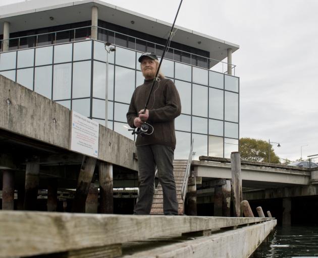 Kelvin Sampson, of Waikouaiti, fishes off the Steamer Basin pontoon (below). PHOTOS: GERARD O’BRIEN