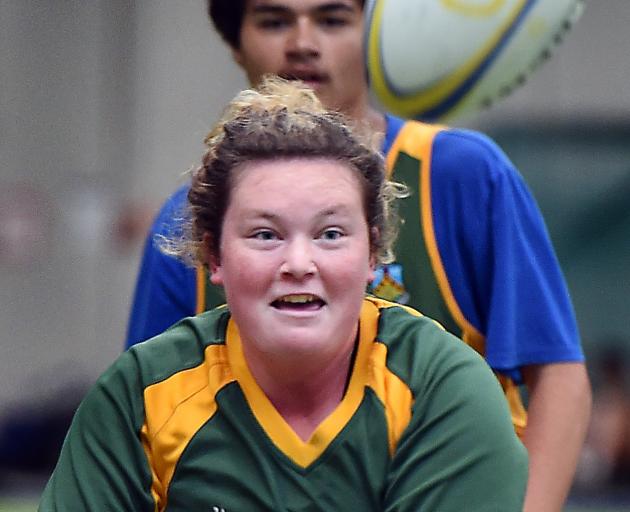Amy Turner (15, left), of East Otago High School, looks to move the ball in a Rippa Rugby match...