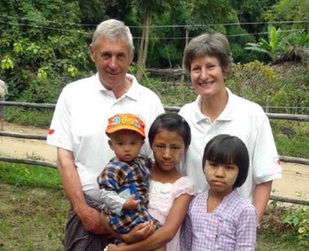 Ken and Margaret Tustin pictured with local children in Myanmar in 2013. PHOTO: SUPPLIED