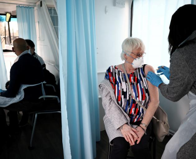 A woman receives a dose of the Oxford-AstraZeneca vaccine in Thamesmead, London. Photo: Reuters 