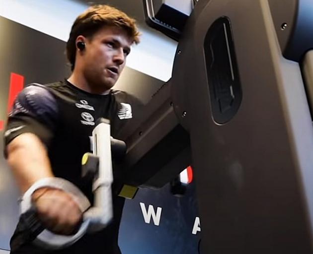 Finn Henry works on a grinder as he trains with Team New Zealand. PHOTO: YOUTUBE