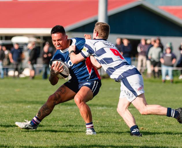 Woodlands back Joe Gillies is tackled by Star halfback Zac Thomas at Woodlands on Saturday. PHOTO...