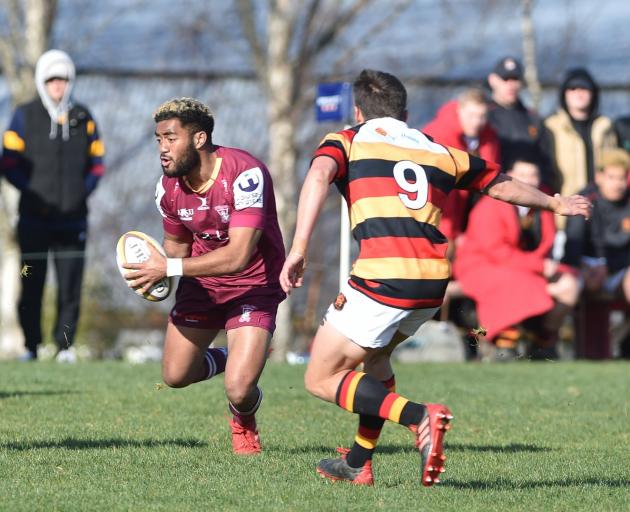 Kaikorai winger Jordan McEntee attempts to avoid the tackle of Zingari-Richmond opposite Willie...
