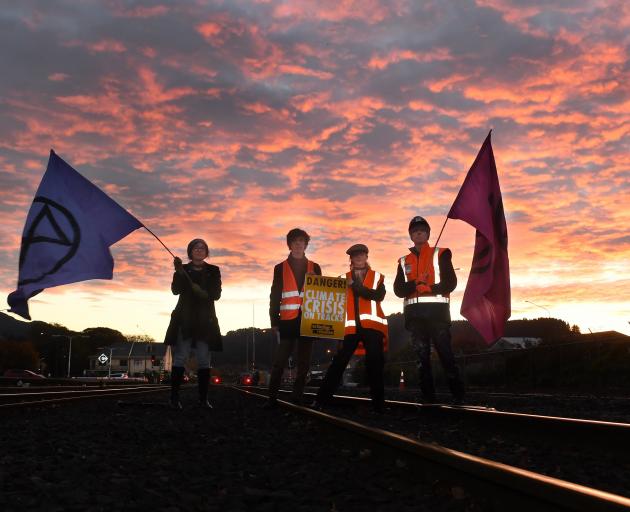 Extinction Rebellion Otepoti activists block the railway line at the Dunedin Railway Station to...