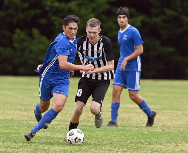 Mosgiel’s Rahan Ali (left) looks to get past Northern’s Harry Fraser while Rahan’s brother Kasam...