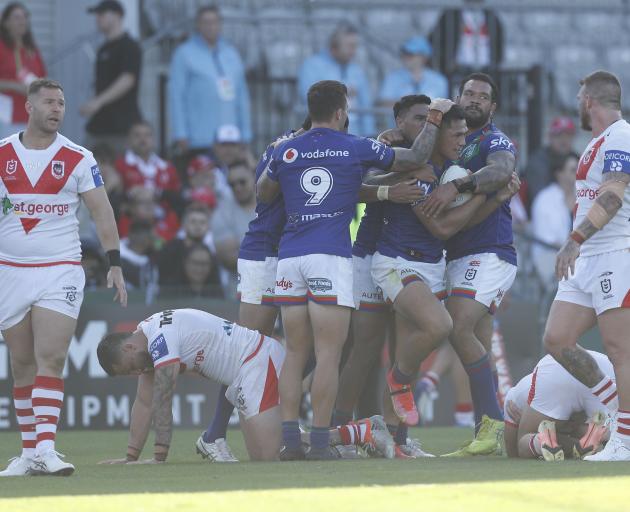 Warriors captain Roger Tuivasa-Sheck is congratulated by team-mates after his match-winning try...