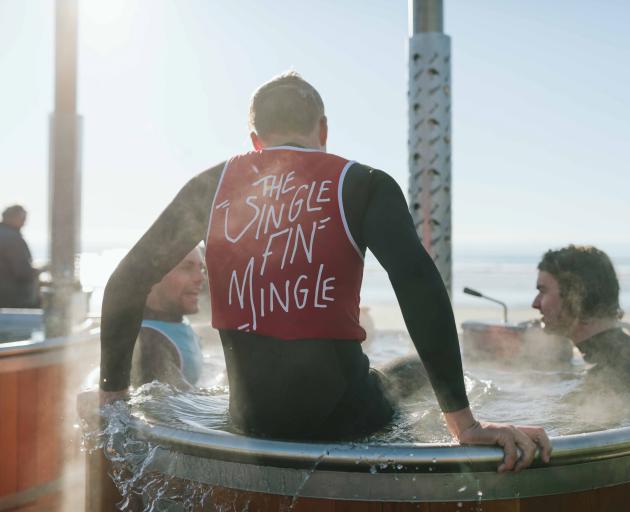 Surfers warm up in hot tubs. Photo: Jonathan Smit
