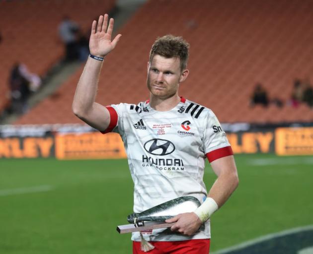 Crusaders halfback Mitchell Drummond acknowledges the crowd at a ceremony marking his 100th Super...