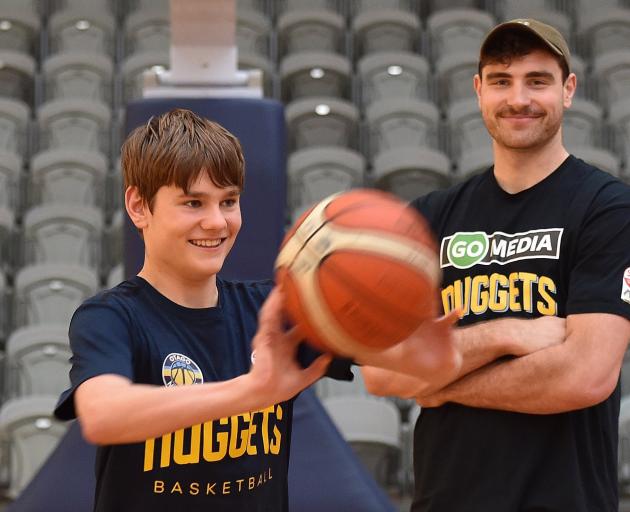 Otago Nuggets supporter Charlie Bauchop (14) passes a ball at the Edgar Centre this week as...