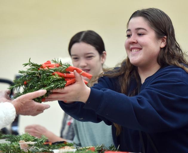Making posies to honour Dunedin’s war veterans yesterday were Ashleigh Thompson (15, left) and...