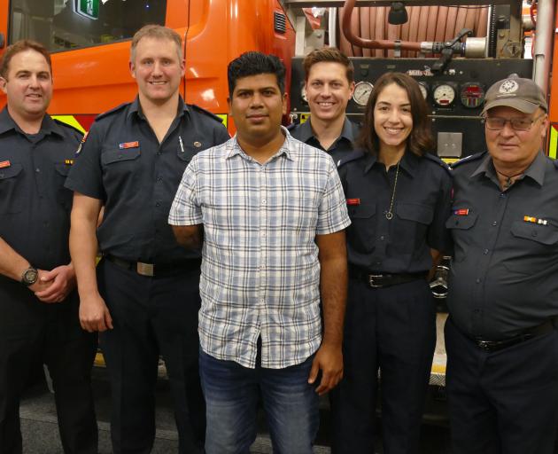 Lochana Kulasiri (centre), of Queenstown, pictured with some of the volunteer firefighters who...