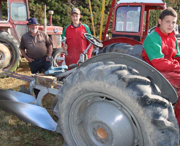 Dave McDonald of Gore has been teaching his grandsons, Flynn (left) and Riley, how to plough and...